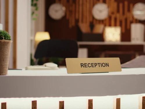 hotel lobby desk with reception sign