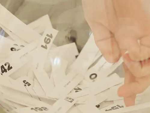 Hand reaching in bowl for raffle winner