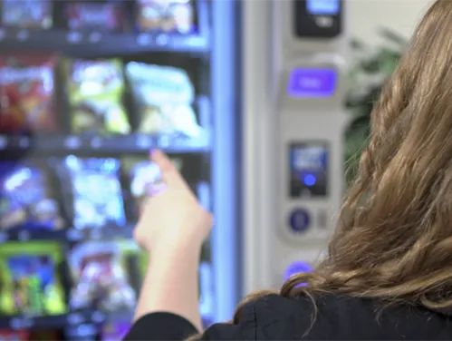 person choosing items from vending machine
