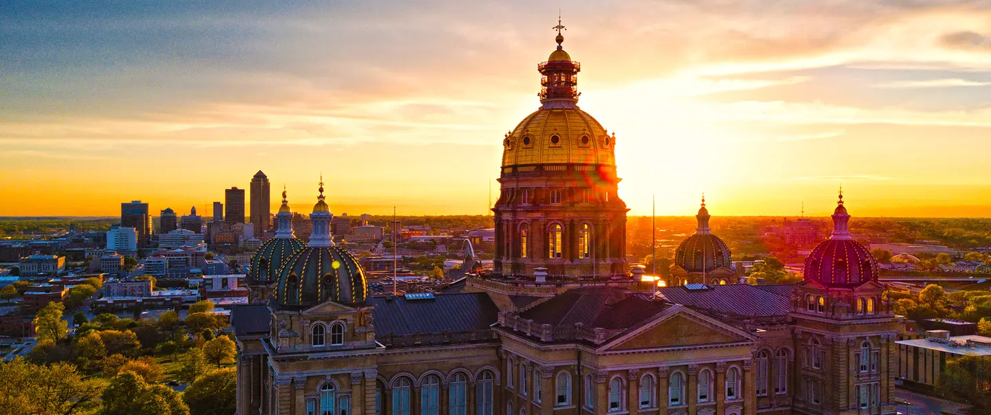 A view of the Iowa State Capitol building at sunset