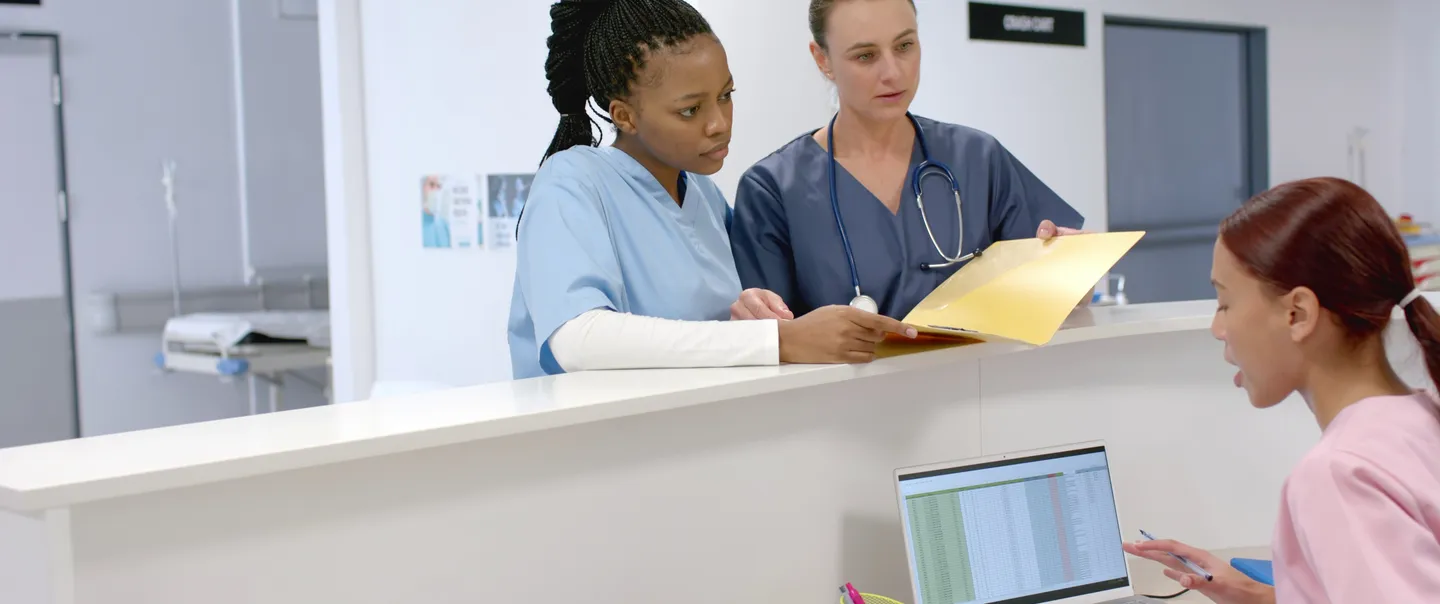diverse group of nurses talking at counter talking