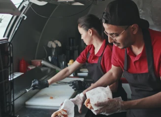 people preparing food in food truck