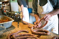 Two men making sausages