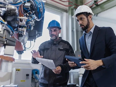 two males evaluating machinery 