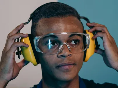 young man putting hearing protection on